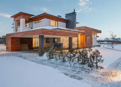 Modern house with wooden accents in a snowy landscape